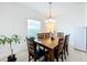 Cozy dining area featuring a wooden table with seating for six and a bright window at 361 Annabelle Way, Davenport, FL 33837