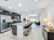 Open-concept kitchen with a large island, stainless steel appliances, and modern finishes at 361 Annabelle Way, Davenport, FL 33837