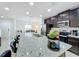 Bright kitchen with stainless steel appliances, granite countertops, and a view to the dining area at 361 Annabelle Way, Davenport, FL 33837