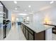 Spacious kitchen featuring a large center island with a sink, stainless steel appliances, and tiled flooring at 361 Annabelle Way, Davenport, FL 33837
