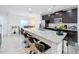 Modern kitchen features a granite island with bar stool seating and stainless steel appliances at 361 Annabelle Way, Davenport, FL 33837