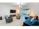 Bright living room with contemporary furnishings, tile flooring, and sliding glass door at 361 Annabelle Way, Davenport, FL 33837