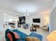 Open concept living room featuring tile flooring, a TV, and seamless transition to the kitchen at 361 Annabelle Way, Davenport, FL 33837