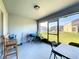 Covered patio with exterior views features a blue grill, table, and chairs at 361 Annabelle Way, Davenport, FL 33837