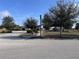 A charming community park view featuring lush greenery, a street lamp and a inviting playground at 361 Annabelle Way, Davenport, FL 33837