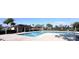 A community pool with a brick deck is surrounded by palm trees and a building for residents at 361 Annabelle Way, Davenport, FL 33837
