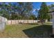 A sprawling green backyard with a wood fence line and a mature shade tree at 3827 Anna Dr, Apopka, FL 32703