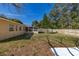 A generous backyard with a storage shed, green grass, and mature trees at 3827 Anna Dr, Apopka, FL 32703