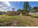 A spacious backyard featuring healthy green grass and a screened-in patio at 3827 Anna Dr, Apopka, FL 32703