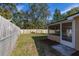 Fenced backyard view with grass, trees, and a screened porch, offering outdoor living space at 3827 Anna Dr, Apopka, FL 32703
