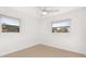 Bright bedroom features tile flooring, a ceiling fan, and natural light from two windows at 3827 Anna Dr, Apopka, FL 32703