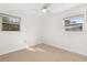 Bright bedroom features tile flooring, a ceiling fan, and natural light from two windows at 3827 Anna Dr, Apopka, FL 32703