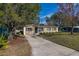A well-maintained house is showcased with a long driveway and lush green landscaping at 3827 Anna Dr, Apopka, FL 32703