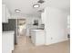 Modern kitchen featuring white cabinets, stainless steel appliances, and tile floors at 3827 Anna Dr, Apopka, FL 32703