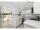 Well-lit kitchen with white cabinetry, marble countertops, and seamless access to the screened porch at 3827 Anna Dr, Apopka, FL 32703