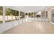 Enclosed lanai features tile flooring, screen windows, and views of backyard at 3827 Anna Dr, Apopka, FL 32703