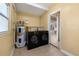 A functional laundry room featuring a washer, dryer, and water heater with tile flooring at 3827 Anna Dr, Apopka, FL 32703