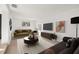 Cozy, renovated living room decorated with modern furniture, plants, and paintings at 3827 Anna Dr, Apopka, FL 32703