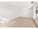 Clean living room featuring neutral tile flooring leading to a well-lit doorway at 3827 Anna Dr, Apopka, FL 32703