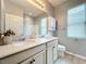 Bright bathroom featuring a double sink vanity, quartz countertop, modern fixtures, and a large mirror at 3857 San Isidro Cir, St Cloud, FL 34772