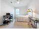 The bedroom has a fan, desk and chair, a small bed, and carpet at 3857 San Isidro Cir, St Cloud, FL 34772