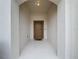 A covered front entrance with a light above the door and a door mat at 3857 San Isidro Cir, St Cloud, FL 34772
