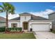 Charming one-story home with a two car garage, mature landscaping, and a well maintained lawn at 3857 San Isidro Cir, St Cloud, FL 34772
