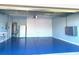 Spacious garage with blue epoxy floors, ready for projects and storage at 3857 San Isidro Cir, St Cloud, FL 34772