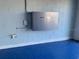 View of the power storage unit in the garage on a light blue brick wall at 3857 San Isidro Cir, St Cloud, FL 34772