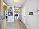 A wide hallway boasts tile floors, neutral paint, and plenty of wall decor at 3857 San Isidro Cir, St Cloud, FL 34772