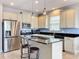 Modern kitchen with stainless steel appliances, granite countertops, and center island with bar stool seating at 3857 San Isidro Cir, St Cloud, FL 34772