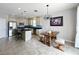 Open kitchen with stainless steel appliances, a center island with bar seating, and an adjacent dining area at 3857 San Isidro Cir, St Cloud, FL 34772