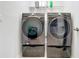 Modern laundry room with high-end washer and dryer on pedestals at 3857 San Isidro Cir, St Cloud, FL 34772