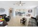 Bright living room with tile flooring, ceiling fan, comfortable seating and an adjacent kitchen area at 3857 San Isidro Cir, St Cloud, FL 34772