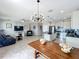 Open concept living area with kitchen, tile floors, modern lighting, and comfortable seating arrangements at 3857 San Isidro Cir, St Cloud, FL 34772