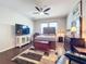 Cozy main bedroom featuring a wood-accented bed frame, ceiling fan, and ample natural light at 3857 San Isidro Cir, St Cloud, FL 34772