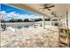 A stunning covered patio with ceiling fans overlooks a gorgeous pool and brick-paved pool deck at 3857 San Isidro Cir, St Cloud, FL 34772