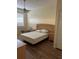 Bright bedroom with wood laminate flooring, a ceiling fan, and a large window at 4010 San Gallo Dr # 105, Kissimmee, FL 34741