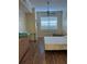 Bright bedroom with wood laminate flooring, a ceiling fan, and a large window at 4010 San Gallo Dr # 105, Kissimmee, FL 34741