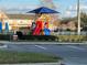 Community playground with a colorful play structure, shade canopy, and safety fencing at 4010 San Gallo Dr # 105, Kissimmee, FL 34741