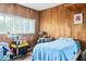 Wood paneled bedroom with wood floor, window and bed at 4126 Montrose Ct, Orlando, FL 32812