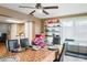 Eat-in dining room with a ceiling fan, and a view into the kitchen and the outside through a large window at 4126 Montrose Ct, Orlando, FL 32812