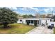 Cozy home featuring a lawn, mature tree, and a screened-in porch at 4126 Montrose Ct, Orlando, FL 32812