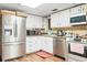 Well-lit kitchen featuring stainless steel appliances and ample cabinet space at 4126 Montrose Ct, Orlando, FL 32812