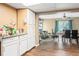 Bright kitchen area flowing into the adjacent dining space and featuring hardwood floors at 4126 Montrose Ct, Orlando, FL 32812