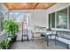 Enclosed porch with tiled floor, wood ceiling, views, and inviting seating area at 4126 Montrose Ct, Orlando, FL 32812