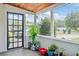 Cozy enclosed porch featuring a tiled floor, exterior views and lots of plants at 4126 Montrose Ct, Orlando, FL 32812
