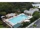 Aerial view of a community pool, hot tub, playground, and amenity center surrounded by lush landscaping at 440 Water St # 440, Celebration, FL 34747