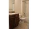 Well-lit bathroom featuring a tiled floor, vanity with granite top, and a shower-tub combo at 441 Squires Grove Dr, Winter Haven, FL 33880