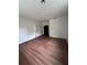 Spacious bedroom with hardwood floors, fresh paint, and an open closet at 451 Sw 2Nd St, Ocala, FL 34471